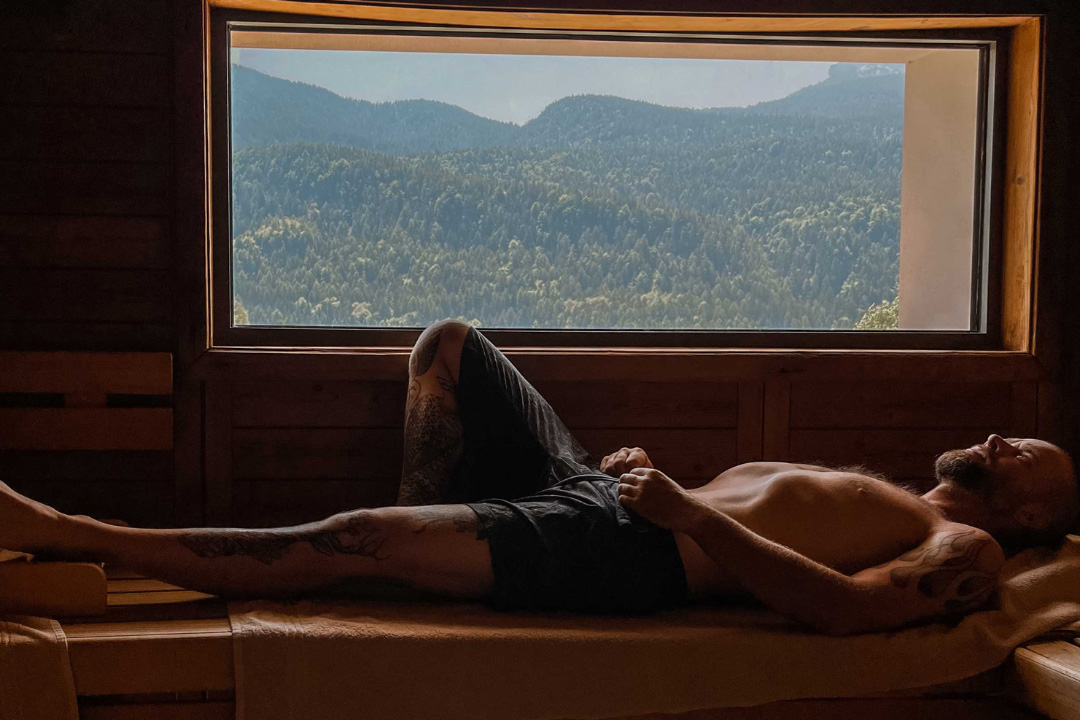 A man is resting while lying in a sauna