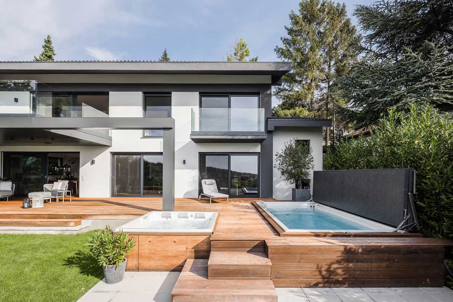 USSPA spa and swim spa pools with raised covers installed beside the terrace of a modern house