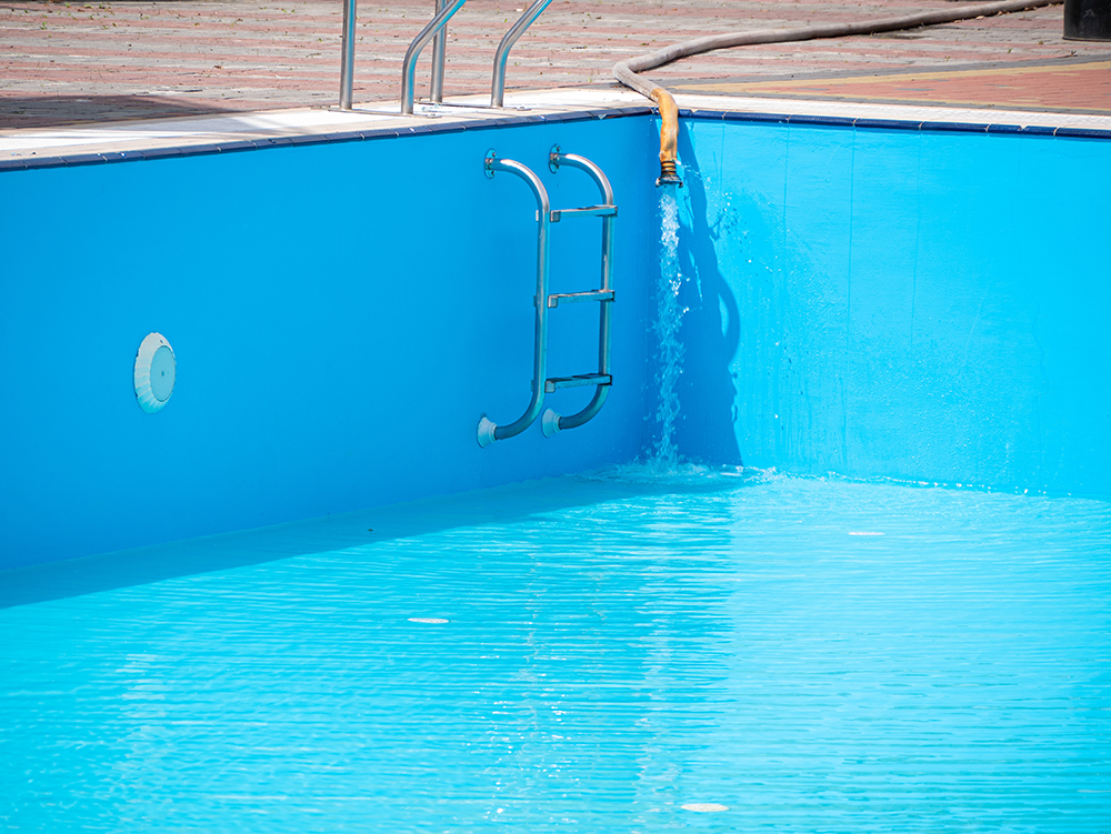 water being filled into an outdoor pool
