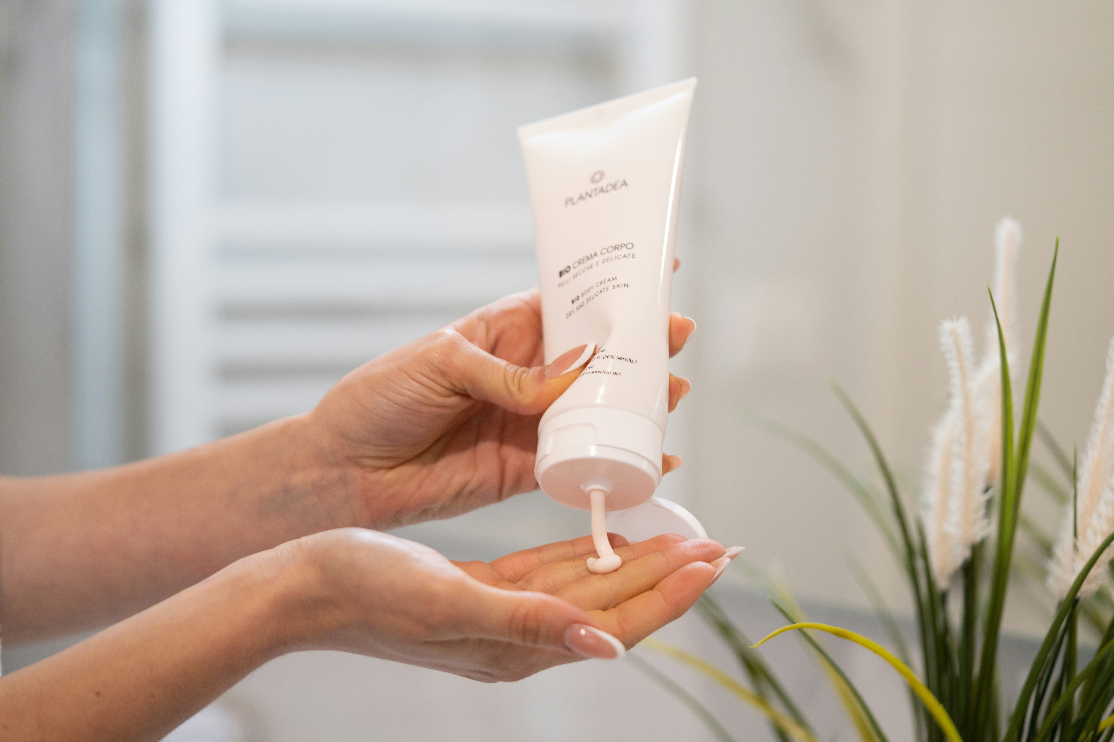 Body cream pressed into the palm of the hand, skin moisturizing and care after a sauna or heat therapy